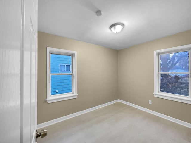 empty room with light wood-type flooring and baseboards