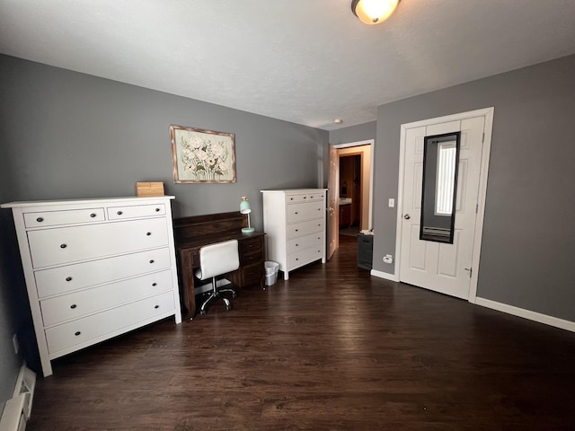 bedroom featuring a baseboard radiator, dark wood finished floors, and baseboards