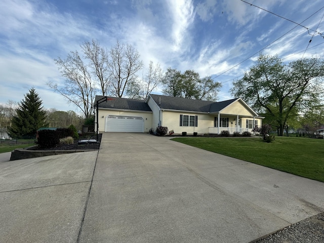 single story home featuring a front yard, concrete driveway, covered porch, and an attached garage