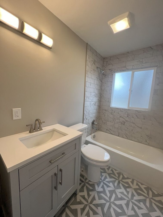 bathroom featuring tub / shower combination, vanity, and toilet