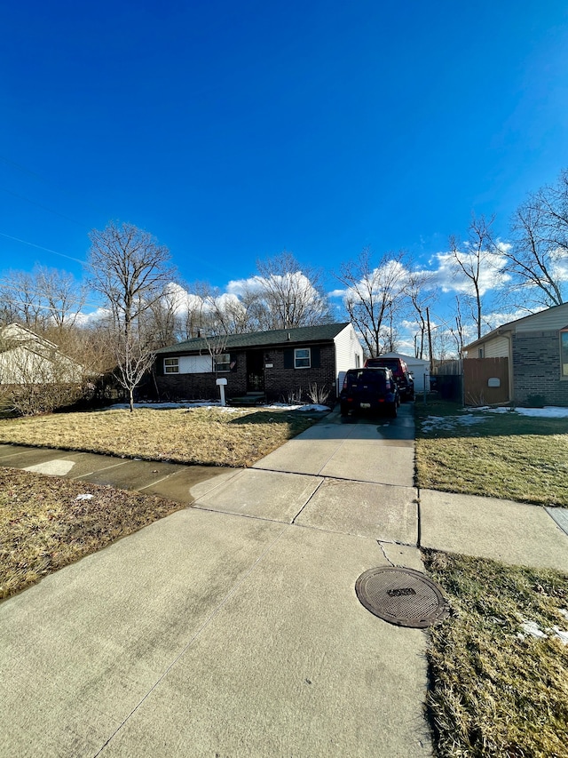 view of front of house with concrete driveway and brick siding