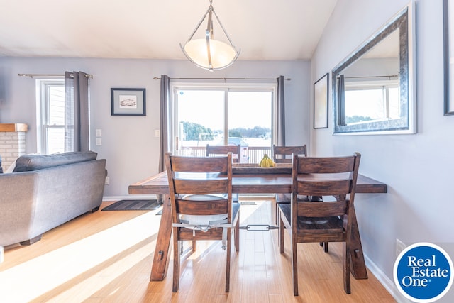 dining area with light wood finished floors and baseboards