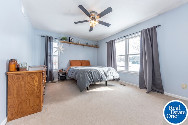 bedroom with light carpet, baseboards, visible vents, and a ceiling fan