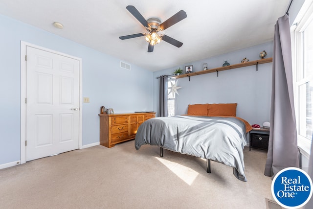 bedroom featuring carpet floors, visible vents, and baseboards