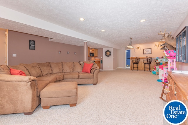 living room with recessed lighting, light colored carpet, a textured ceiling, and a bar