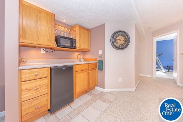 kitchen featuring light colored carpet, light countertops, black appliances, a textured ceiling, and baseboards