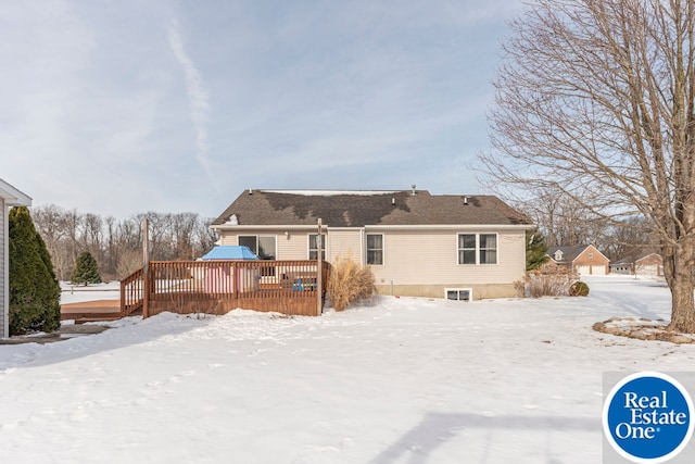 snow covered rear of property featuring a wooden deck