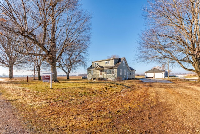 view of front of house with an outbuilding and a front yard