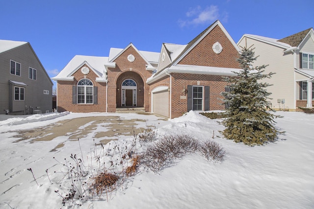 view of front of home featuring brick siding and an attached garage