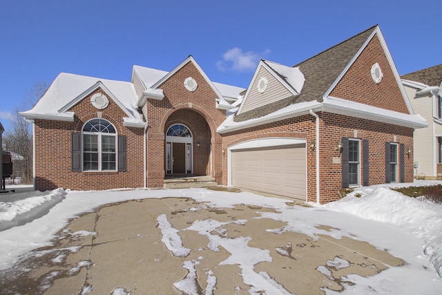 view of front of property featuring brick siding and an attached garage