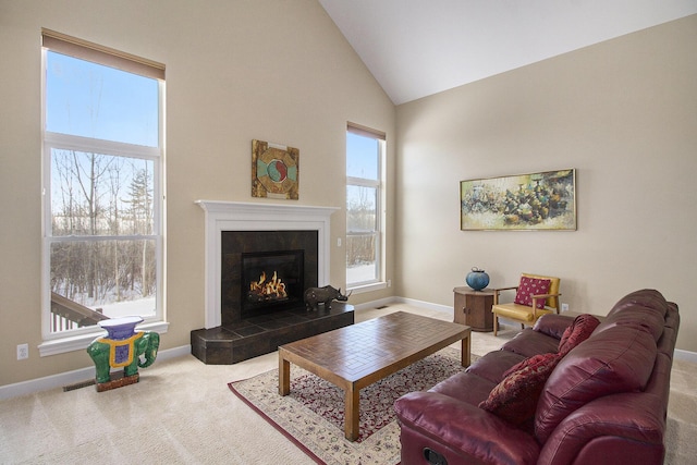 carpeted living area featuring high vaulted ceiling, plenty of natural light, visible vents, and a fireplace