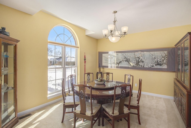 dining space featuring plenty of natural light, visible vents, and light colored carpet