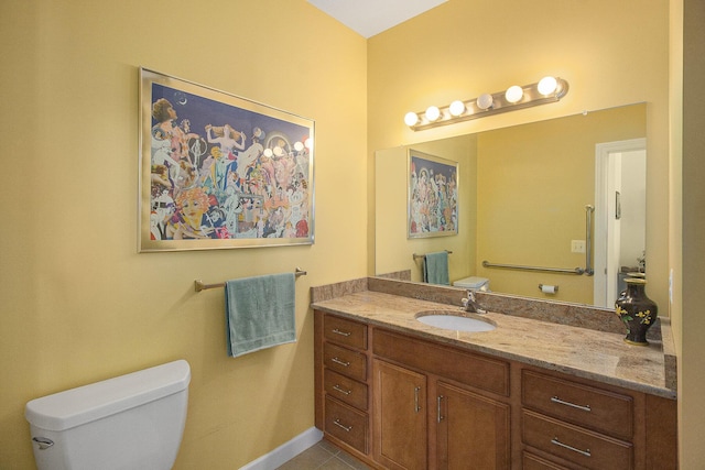 bathroom with toilet, tile patterned flooring, vanity, and baseboards