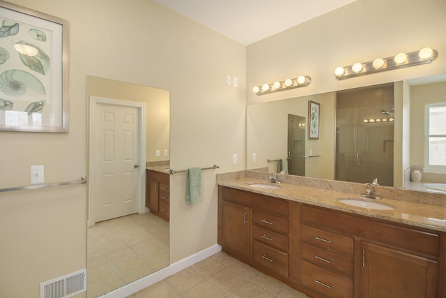 bathroom featuring a stall shower, tile patterned flooring, visible vents, and a sink