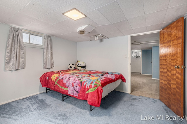 bedroom featuring carpet and baseboards