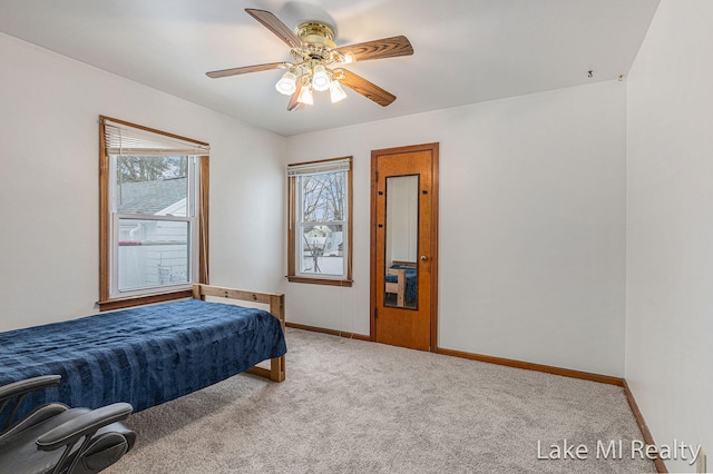 unfurnished bedroom featuring ceiling fan, carpet flooring, and baseboards