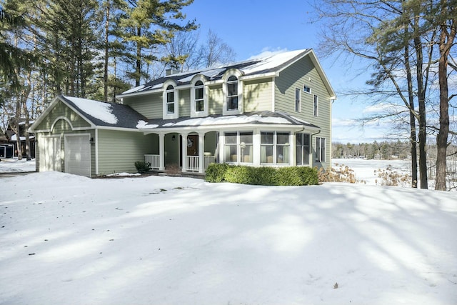 traditional-style home featuring covered porch, a chimney, and an attached garage