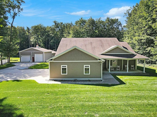 view of front of property with a porch, an outbuilding, a garage, and a front yard