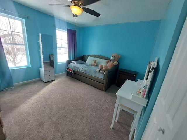 bedroom with light carpet, a ceiling fan, and baseboards