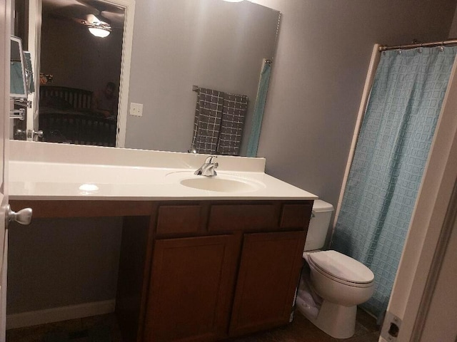 ensuite bathroom featuring a shower with curtain, vanity, toilet, and ensuite bathroom