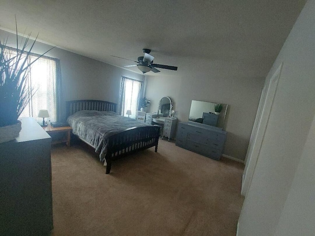 bedroom featuring a ceiling fan and carpet