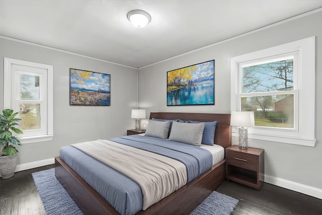 bedroom with dark wood-style flooring, multiple windows, and baseboards