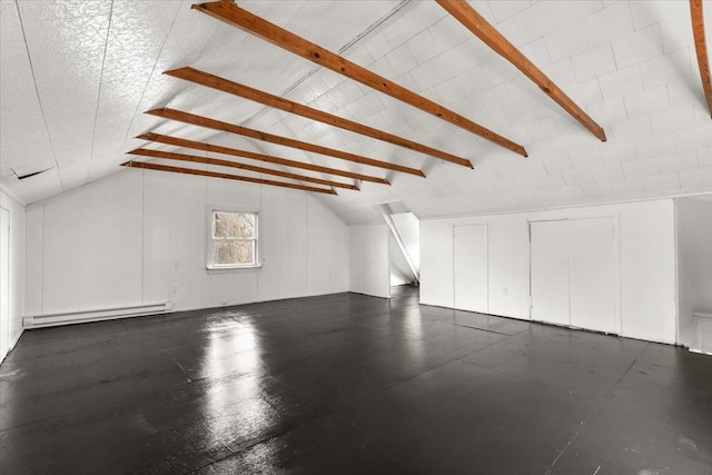 additional living space featuring vaulted ceiling with beams and a baseboard radiator