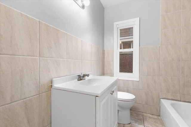 full bath featuring a tub to relax in, toilet, tile walls, and vanity