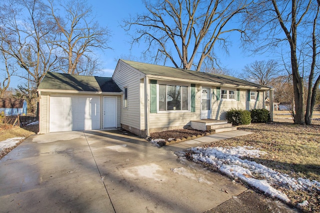 ranch-style home featuring a garage and driveway