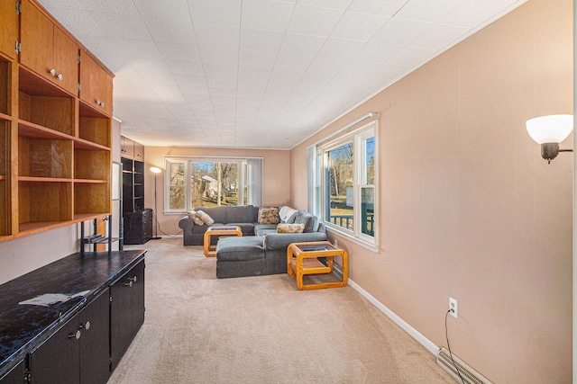 living area featuring baseboards and light colored carpet