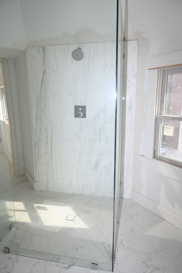 full bathroom with marble finish floor and a marble finish shower