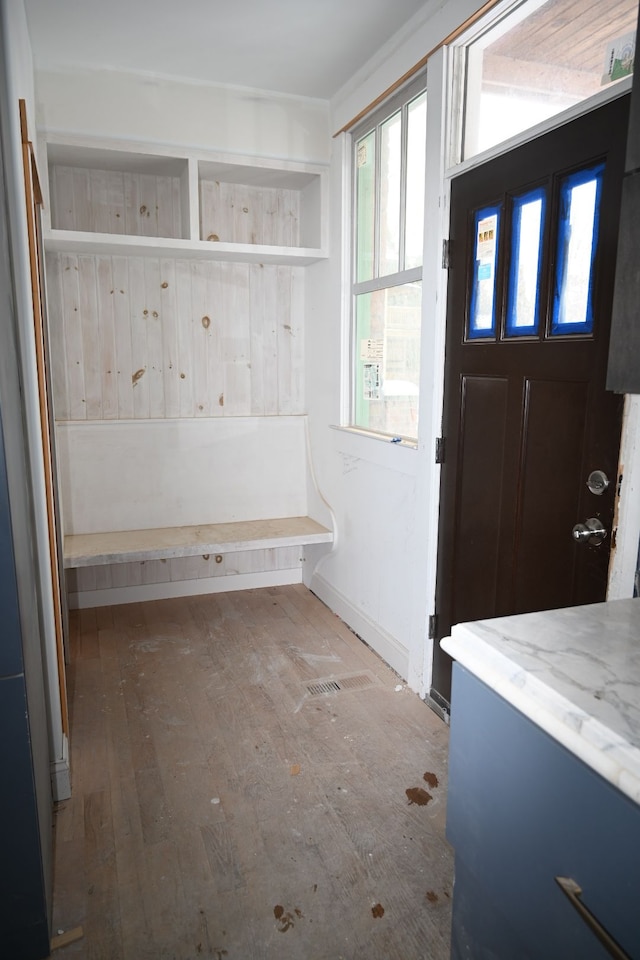 mudroom with wood-type flooring and baseboards