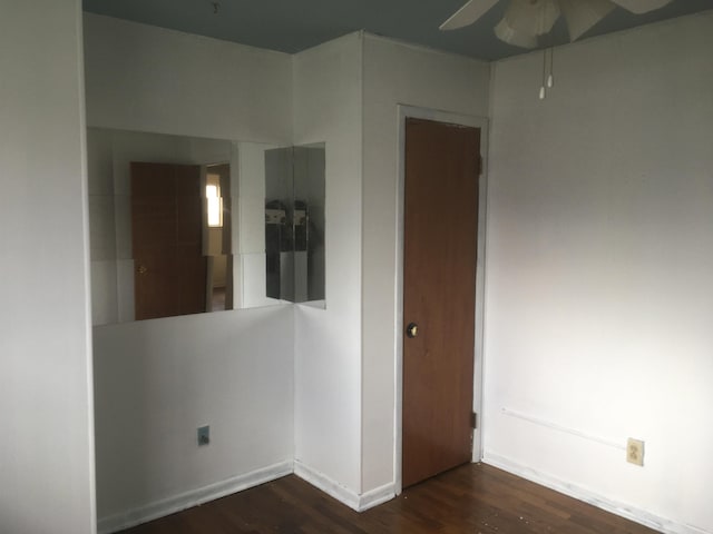 empty room featuring ceiling fan and wood finished floors