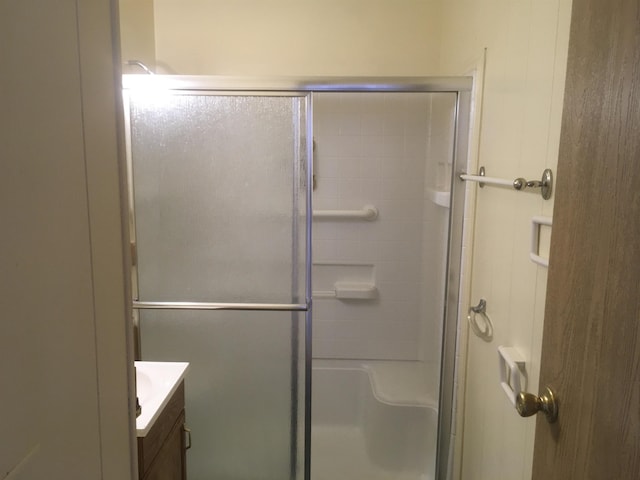 bathroom with a shower stall and vanity