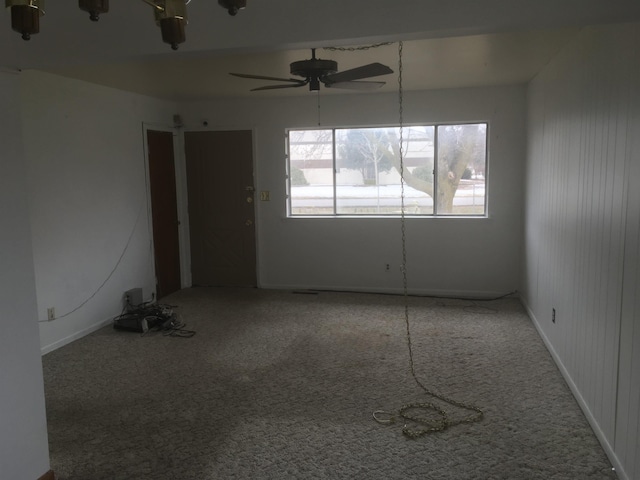 carpeted spare room with ceiling fan