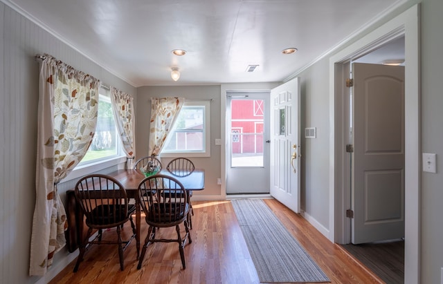 dining area with visible vents, dark wood finished floors, and baseboards