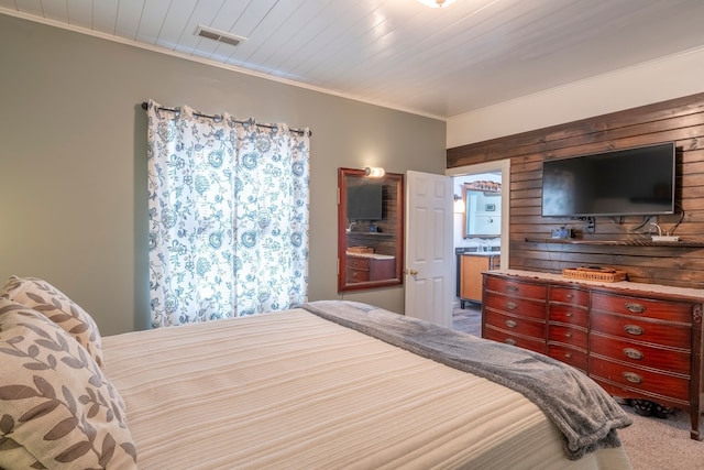 carpeted bedroom with wood ceiling, visible vents, and crown molding