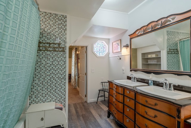 bathroom featuring double vanity, a shower with curtain, a sink, and wood finished floors