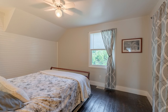 bedroom with baseboards, visible vents, lofted ceiling, ceiling fan, and dark wood-style flooring