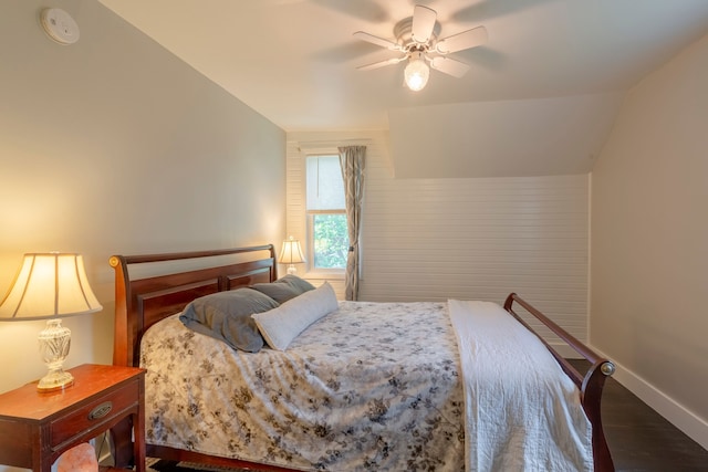 bedroom featuring lofted ceiling, ceiling fan, baseboards, and wood finished floors