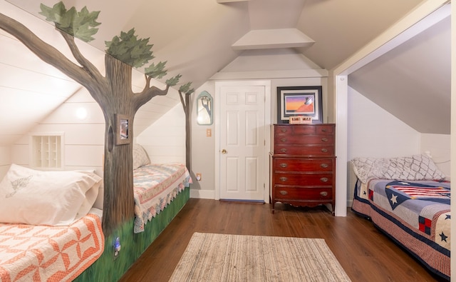 bedroom with dark wood-type flooring and lofted ceiling