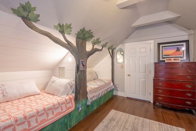 bedroom with vaulted ceiling and dark wood-style flooring