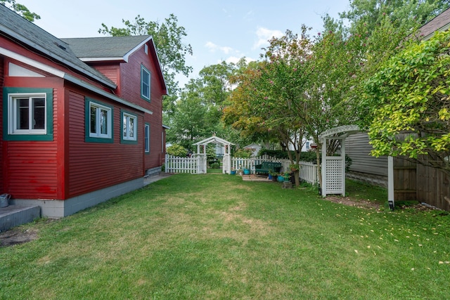 view of yard with a fenced backyard and an outbuilding