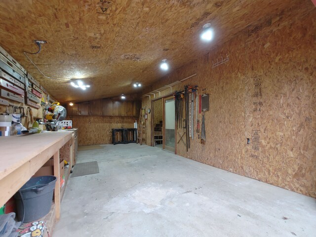 interior space with concrete flooring, washer / dryer, and a workshop area