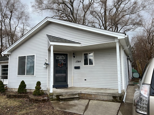 view of front of property featuring covered porch and roof with shingles