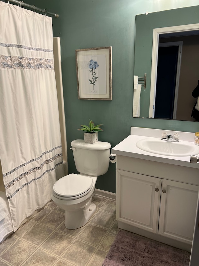 bathroom with tile patterned flooring, vanity, and toilet