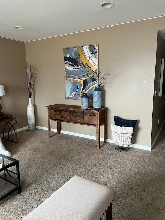 sitting room featuring carpet floors and baseboards