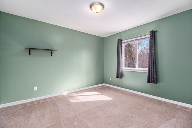 spare room with carpet and baseboards