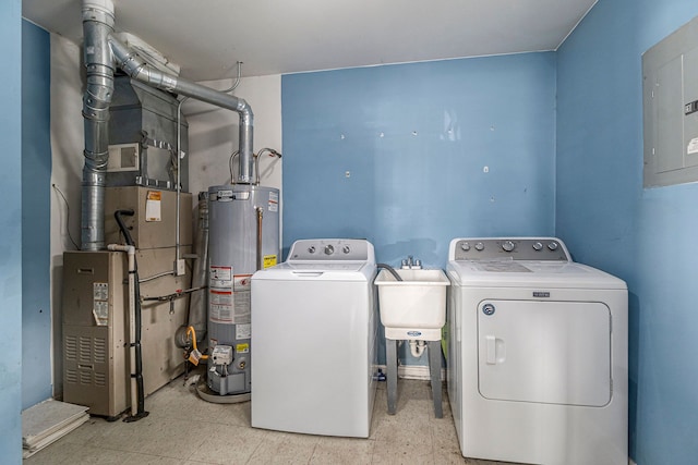 washroom featuring laundry area, separate washer and dryer, a sink, water heater, and tile patterned floors