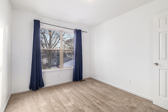 unfurnished room with carpet floors and baseboards